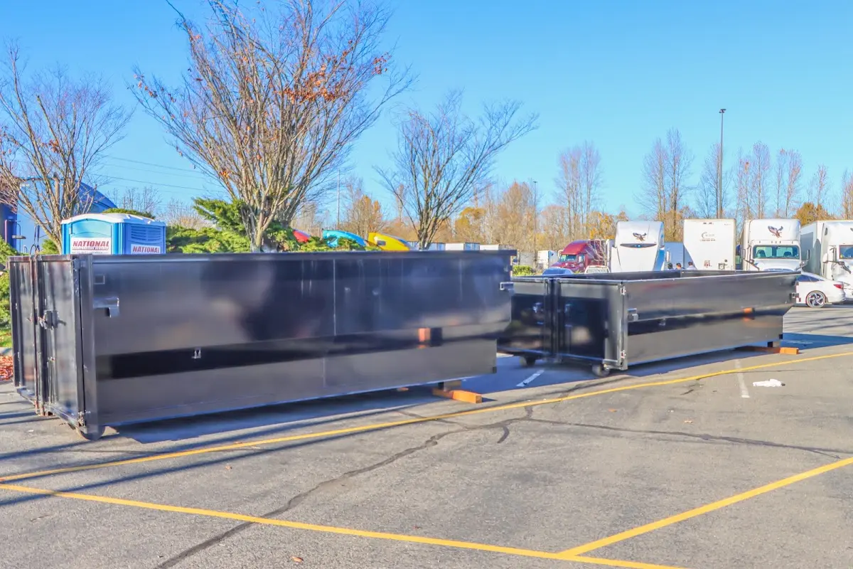 Professional dumpster rental service with roll-off container on residential driveway in Madison Heights